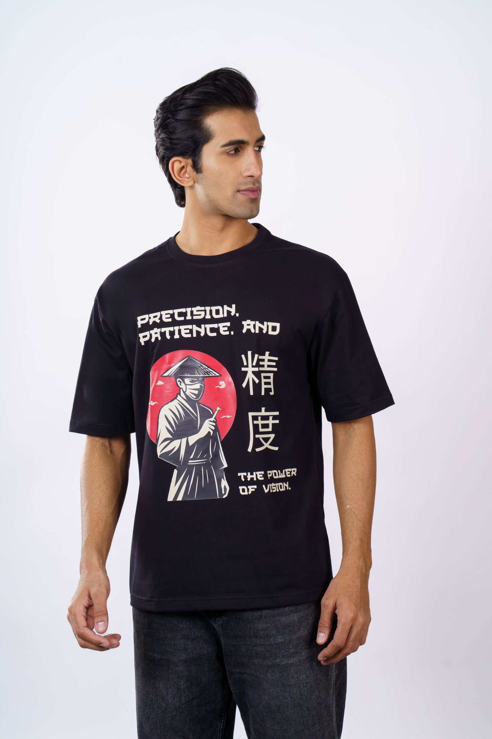 Stylish black t-shirt with graphic cartoon design worn by man against white background.