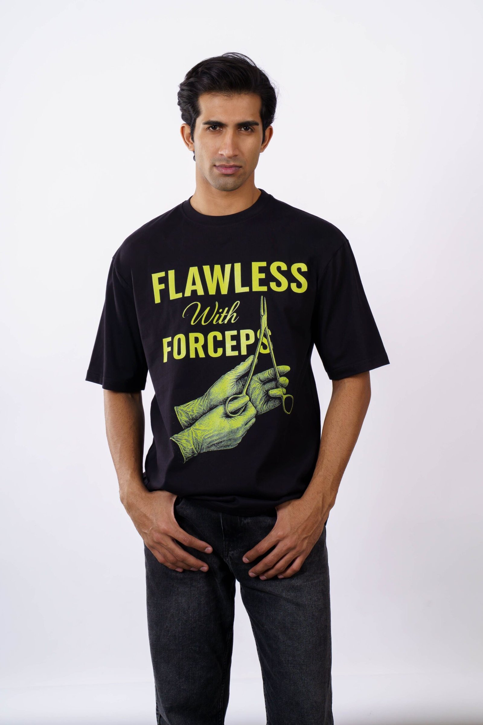 Model wearing a 'Flawless with Forceps' printed oversized t-shirt.